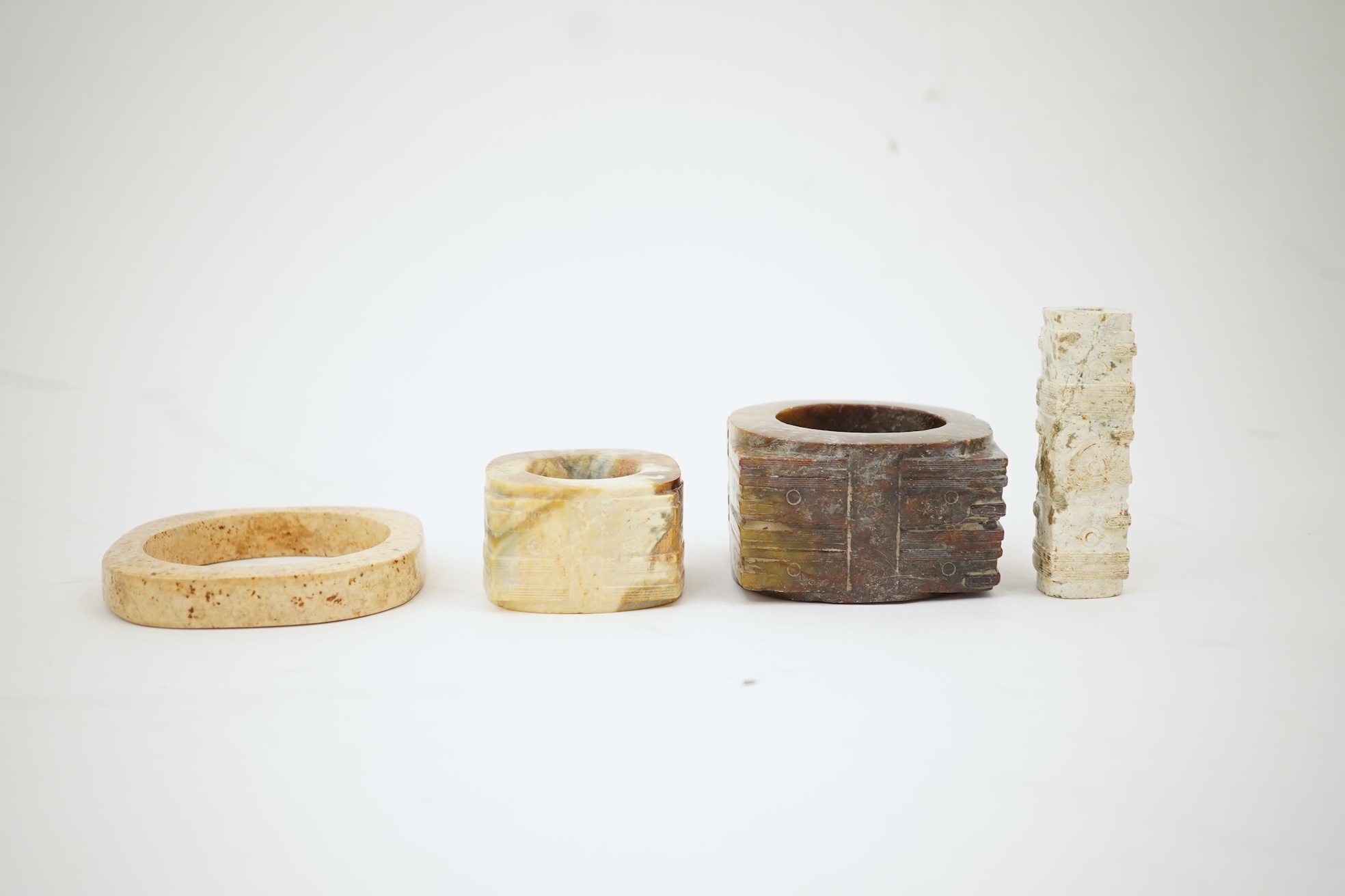 Four Chinese archaistic hardstone or burnt jade cong or cylinders